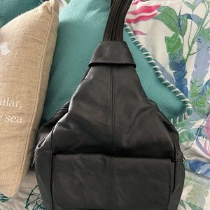 Black leather sling back or backpack style with lots of room, great for travel